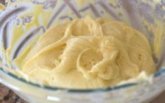 a bowl filled with yellow batter on top of a counter