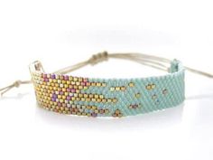 a blue bracelet with gold and pink beads