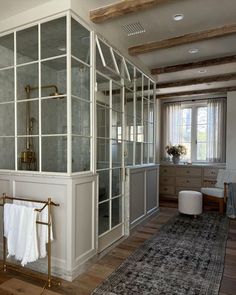 a large white room with glass doors and shelves