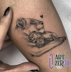 a woman's thigh with a lion and cub tattoo on it