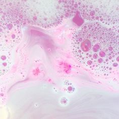 pink and white liquid with bubbles in it