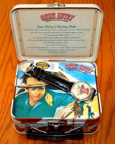 an open tin box with a watch inside