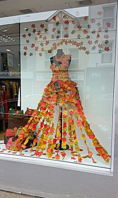 a dress made out of autumn leaves in a store window