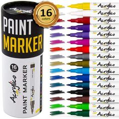 the paint marker is next to several different colors of markers and pens in each tube