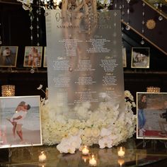 a table topped with pictures and candles next to a sign that says the wedding date