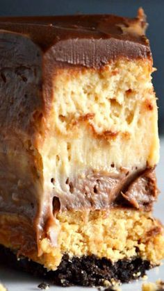 a piece of cake sitting on top of a white plate covered in chocolate and nuts