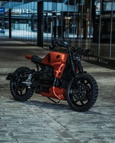 an orange and black motorcycle parked on the street