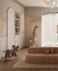 a giraffe is standing in the middle of a living room with two stuffed animals