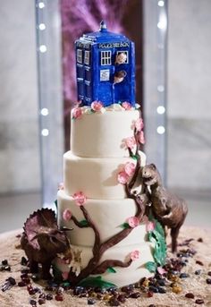 the doctor who themed wedding cake is decorated with flowers and an animal figurine