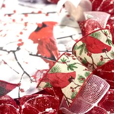 red and white fabric with birds on it sitting next to each other in the snow