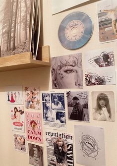 a refrigerator with magnets and pictures on the wall next to a shelf filled with cds