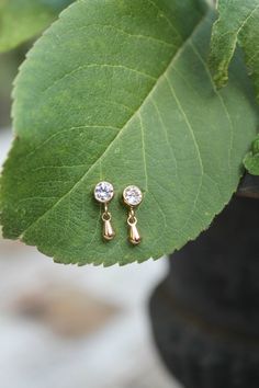 Sweet & dainty pair of 14k gold fill cubic zirconia stud earrings with mini drops. Perfect any-day any time earrings :) Components: 4mm cubic zirconia studs in 14Kt Gold Filled bezels 6mm, 24k gold plated mini drops *14k gold filled components are made with a layer of pure gold over brass base. What you see and what comes in contact with your skin is pure gold. Gold filled is safe for most skin types and considered hypoallergenic. Your item will arrive in a beautifully embossed Jewelry box - Yellow Gold Cubic Zirconia Teardrop Earrings Gift, Dainty Cubic Zirconia Earrings, Dainty Teardrop Dangle Earrings, Dainty Yellow Gold Teardrop Earrings Gift, Dainty Teardrop Earrings, Gold Earrings For Kids, Small Earrings Gold, Embossed Jewelry, Simple Gold Earrings