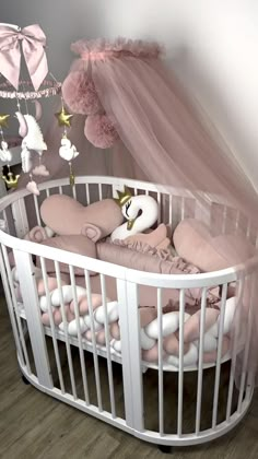 a white crib with a pink canopy and some stuffed animals in it, next to a wooden floor