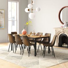 a dining room table with chairs and a fire place