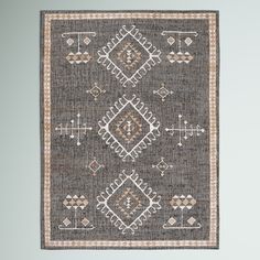 a gray and beige rug with an intricate design