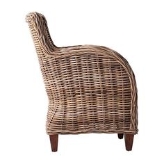 a wicker chair with wooden legs on a white background