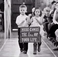 two children are walking down the aisle holding signs that read here comes the love of your life