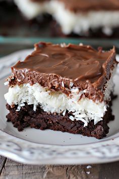 a piece of cake on a plate with chocolate frosting and coconut sprinkles