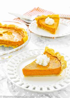 two plates with slices of pumpkin pie on them