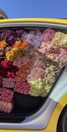 a car filled with lots of different colored flowers