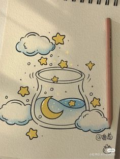 a drawing of a fish bowl with stars and moon in the sky on paper next to a pencil