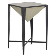 a black and white side table with a triangle design on the top, sitting against a white background