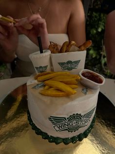 a wedding cake with fries and ketchup on it