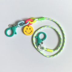 a lanyard with a smiley face on the front and a leash attached to it