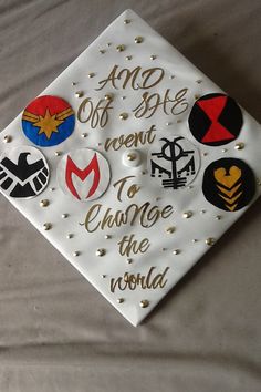 a white graduation cap with gold lettering on it that says, and off to the menu change the world