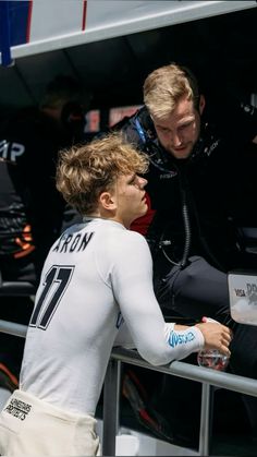 a young man is signing autographs for a fan