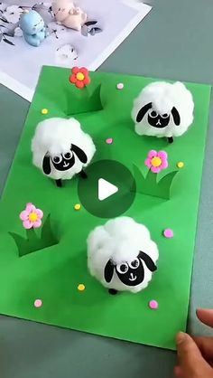 someone is cutting out some paper with sheep on it