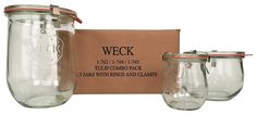 three mason jars with lids are shown in front of a cardboard box that says weck