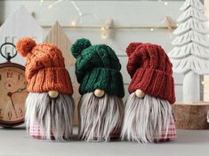 three knitted gnomes sitting next to each other