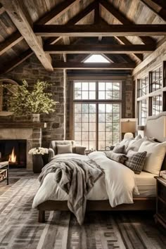 a rustic bedroom with stone walls and wood beams, a large bed in the center