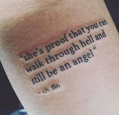 a person with a tattoo saying she's proof that you can walk through hell and still be an angel