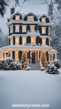 a large house covered in snow with christmas lights on the windows and steps leading up to it