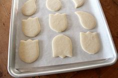 eight uncooked cookies on a baking sheet ready to be baked