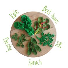 crocheted shamrocks on a wooden plate with words describing the different types of leaves