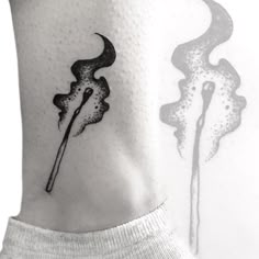 a black and white photo of a tattoo on the back of a woman's neck