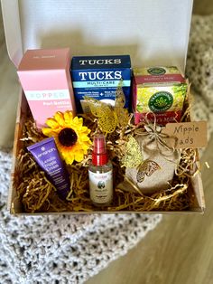 an open box with various items in it sitting on a table next to a doily