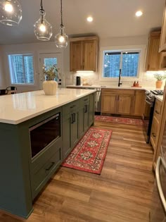 a kitchen with an island, stove and sink in it's center area is shown