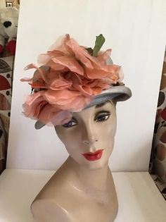 "Vintage 1950's 1960's light Gray Straw hat with Dark Peach flowers. The label is *Grayce Hats*. Does have condition issues and will be sold as is. (SEE PIX). *MORE INFORMATION BELOW* CONDITION: Has discoloration around the inside brim in the front on the straw and on the band/ribbon (SEE PIX). On the inside band on the right side there is a small dark spot. In the back of the hat on the brim area there is some wear. This appears to be from where the hatpin was always used (SEE PIX). Sold As Is! Vintage Gray Hat, Vintage Orange Hat With Curved Brim, Vintage Gray Brimmed Hat, Retro Spring Fascinator Hat, Retro Adjustable Fascinator For Spring, Vintage Gray Hat, One Size, Retro Spring Fascinator, Vintage Gray Hat, One Size Fits Most, Retro Hats For Garden Party