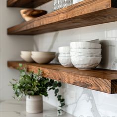 some bowls and plates are sitting on the shelves