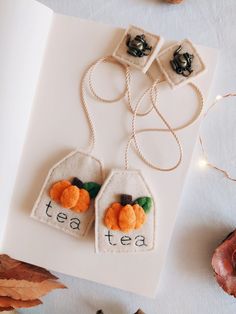 two tea bags with pumpkins on them and the words tea written in small letters