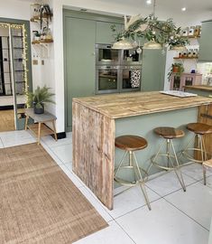 a kitchen island with three stools in front of it