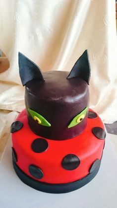 a cake decorated to look like a cat and ladybug