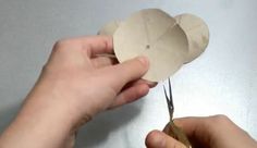 someone is cutting out a paper flower with scissors