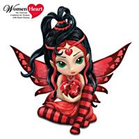 a red and black fairy sitting on the ground with her heart in her hands,