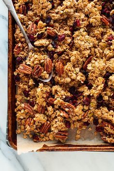 granola with nuts and cranberries in a baking dish