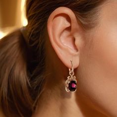 Add a touch of vibrant elegance to your collection with these stunning natural rhodolite garnet earrings, set in luxurious 14K Rose Gold. Featuring two captivating garnets totaling 10.27 carats, these earrings offer a beautiful red-purple hue that is sure to turn heads.  Earring Highlights: Total Carat Weight: 10.27 carats of natural Rhodolite Garnets, showcasing a striking red-purple color that adds a bold and captivating pop to any look. Shape: Oval, offering a classic yet elegant design. Color: Strong red-purple, highlighting the garnets' vibrant and rich tone. Clarity: Very eye clean, ensuring a flawless and radiant appearance. Cut: Brilliant/step cut, designed to maximize the garnets' natural brilliance and sparkle. Treatments: None, preserving the garnets’ natural beauty.  Diamonds: Garnet Jewelry Earrings, Garnet Jewelry, Step Cut, Garnet Earrings, Rhodolite Garnet, Purple Hues, Garnet Gemstone, Rose Gold Earrings, Design Color